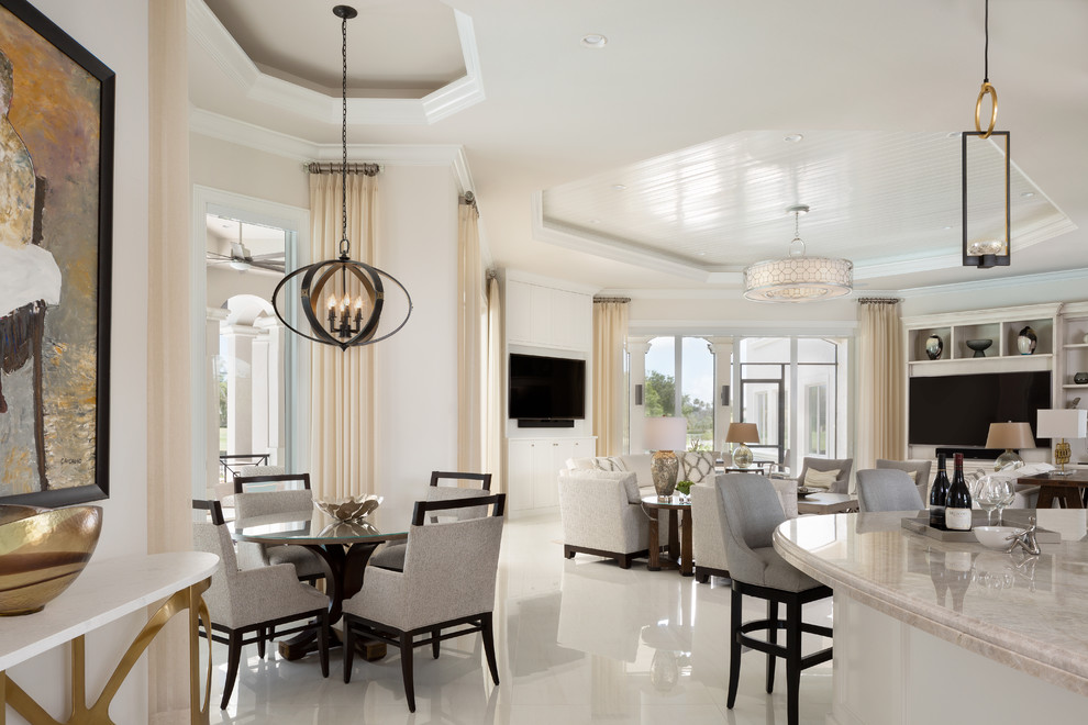 This is an example of a large mediterranean open concept family room in Miami with a home bar, white walls, a wall-mounted tv, white floor and ceramic floors.