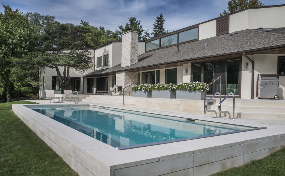 Inspiration for a mid-sized backyard stone and rectangular pool remodel in Chicago