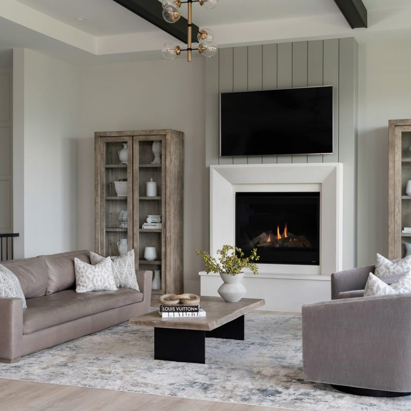 Design ideas for an expansive modern formal open plan living room in Vancouver with white walls, lino flooring, a standard fireplace, a timber clad chimney breast, a built-in media unit, green floors and exposed beams.