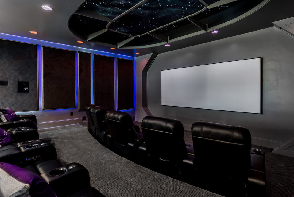 Large transitional open concept home theatre in Salt Lake City with grey walls, carpet, a projector screen and black floor.