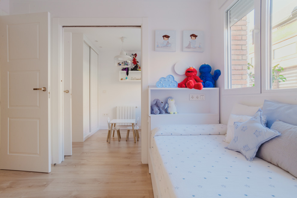 Mid-sized scandinavian gender-neutral kids' room in Other with white walls, medium hardwood floors and brown floor for kids 4-10 years old.