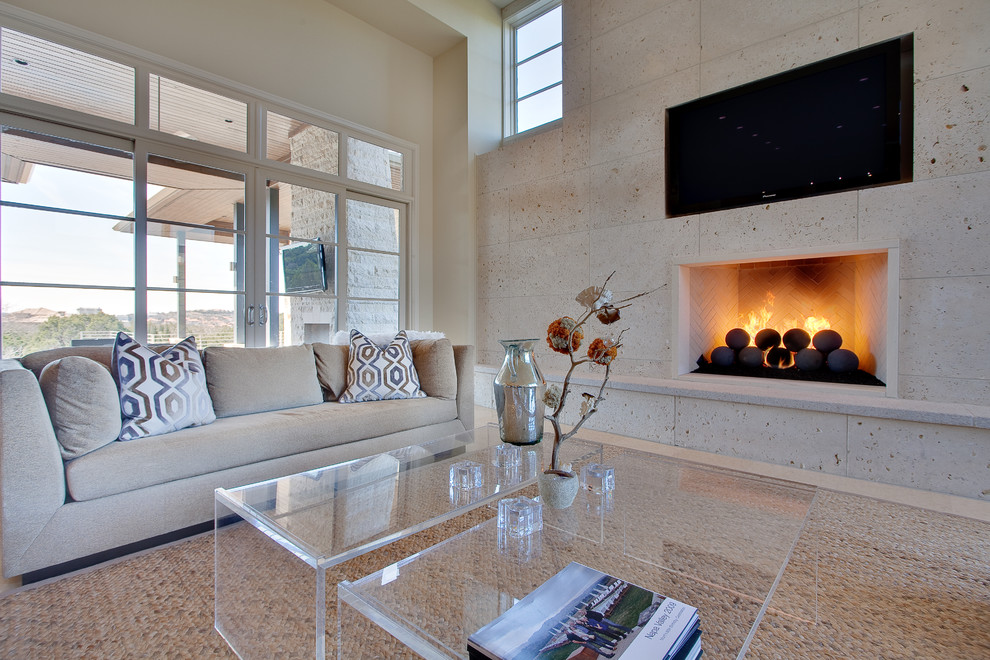 Contemporary living room in Austin with a standard fireplace and a wall-mounted tv.