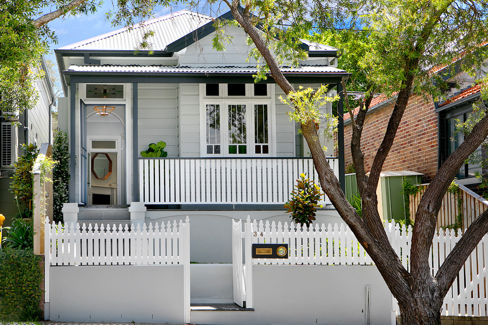 Traditional one-storey grey house exterior in Sydney with wood siding, a metal roof and a gable roof.