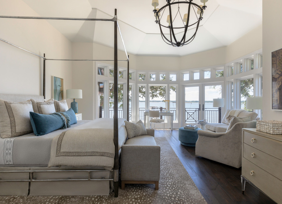 Inspiration for a large mediterranean master bedroom in Jacksonville with white walls, dark hardwood floors, brown floor and vaulted.