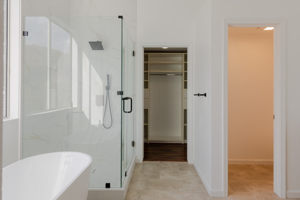 Photo of a medium sized contemporary ensuite bathroom in San Diego with flat-panel cabinets, brown cabinets, a freestanding bath, a corner shower, a one-piece toilet, white tiles, ceramic tiles, white walls, ceramic flooring, a submerged sink, engineered stone worktops, brown floors, a hinged door, white worktops, an enclosed toilet, double sinks, a built in vanity unit and brick walls.