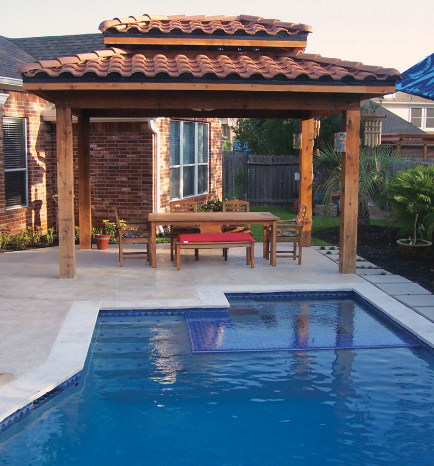 Small asian backyard custom-shaped pool in Houston with a pool house and stamped concrete.
