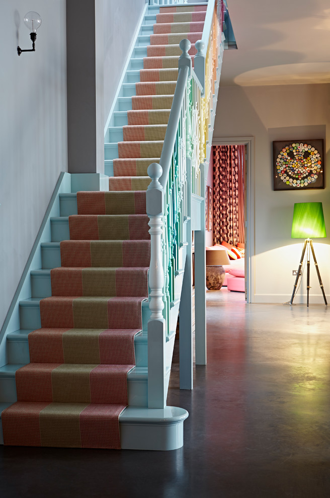 This is an example of an eclectic carpeted straight staircase in Other with carpeted risers.