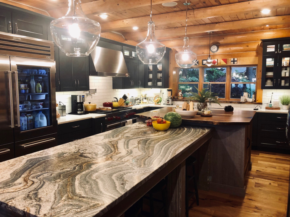 Inspiration for a large transitional l-shaped eat-in kitchen in Grand Rapids with an undermount sink, shaker cabinets, grey cabinets, granite benchtops, white splashback, porcelain splashback, stainless steel appliances, light hardwood floors, with island, beige floor and multi-coloured benchtop.