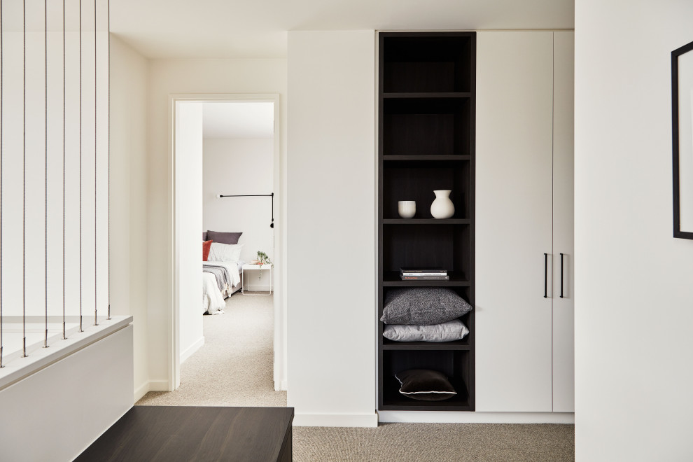 Mid-sized contemporary study room in Melbourne with white walls, carpet, a built-in desk and grey floor.