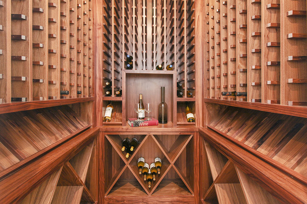 This is an example of an expansive transitional wine cellar in San Francisco with medium hardwood floors, display racks and brown floor.