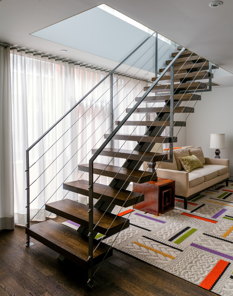 This is an example of a contemporary wood staircase in New York with open risers.