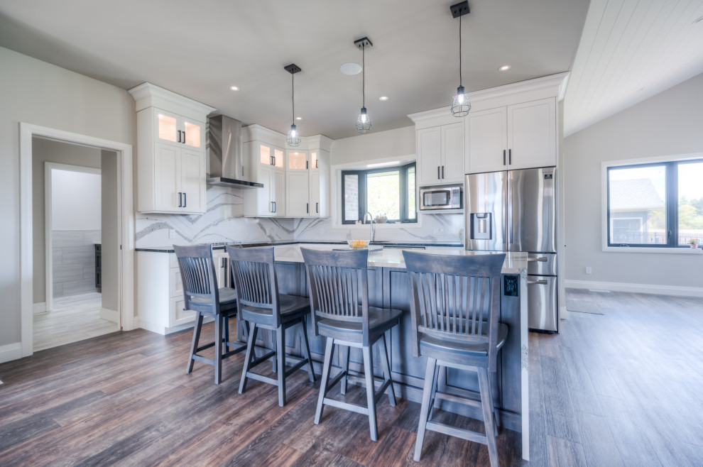 Eat-in kitchen - transitional eat-in kitchen idea with shaker cabinets, white cabinets, stainless steel appliances and an island