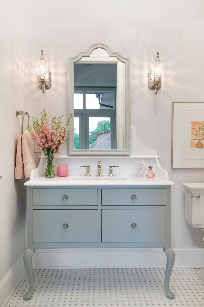 Photo of a traditional bathroom in Minneapolis with furniture-like cabinets, grey cabinets, a drop-in tub, a corner shower, white tile, stone tile, white walls, marble floors, an undermount sink and solid surface benchtops.