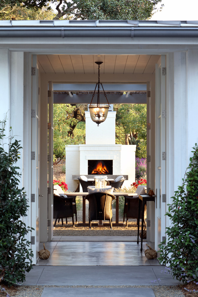 This is an example of an expansive country backyard patio in San Francisco with with fireplace.
