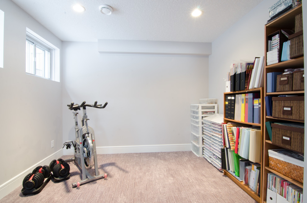 This is an example of a mid-sized contemporary multipurpose gym with beige walls and carpet.