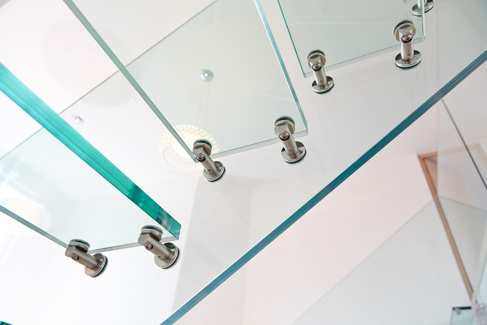 Mid-sized contemporary glass floating staircase in Other with open risers.
