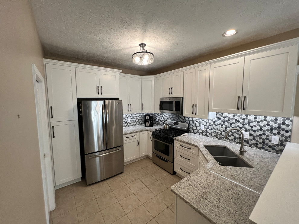 Design ideas for a mid-sized traditional u-shaped eat-in kitchen in Cleveland with shaker cabinets, white cabinets, quartz benchtops and mosaic tile splashback.