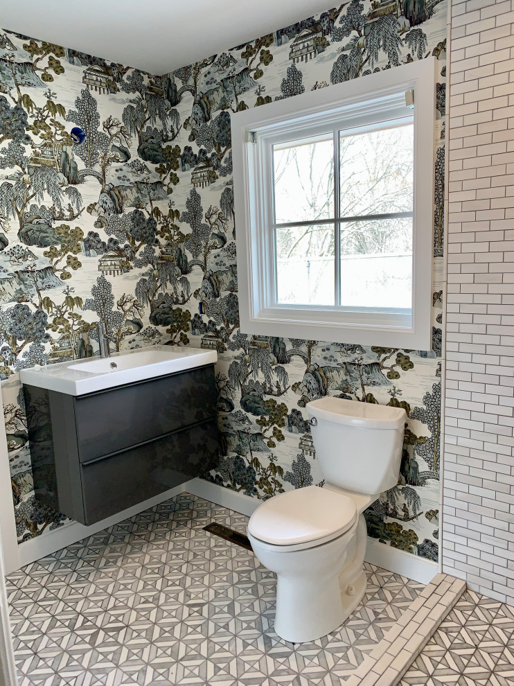 Inspiration for a small mosaic tile floor, gray floor and wallpaper toilet room remodel in Other with furniture-like cabinets, a one-piece toilet and a floating vanity