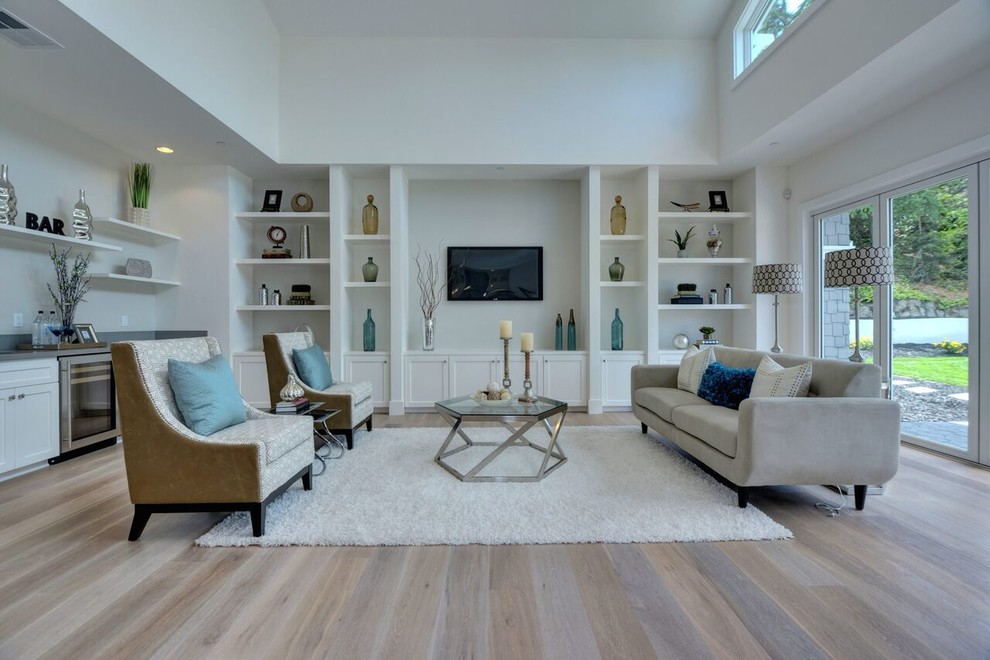 Design ideas for a mid-sized transitional enclosed family room in San Francisco with a home bar, white walls, light hardwood floors, a wall-mounted tv and brown floor.