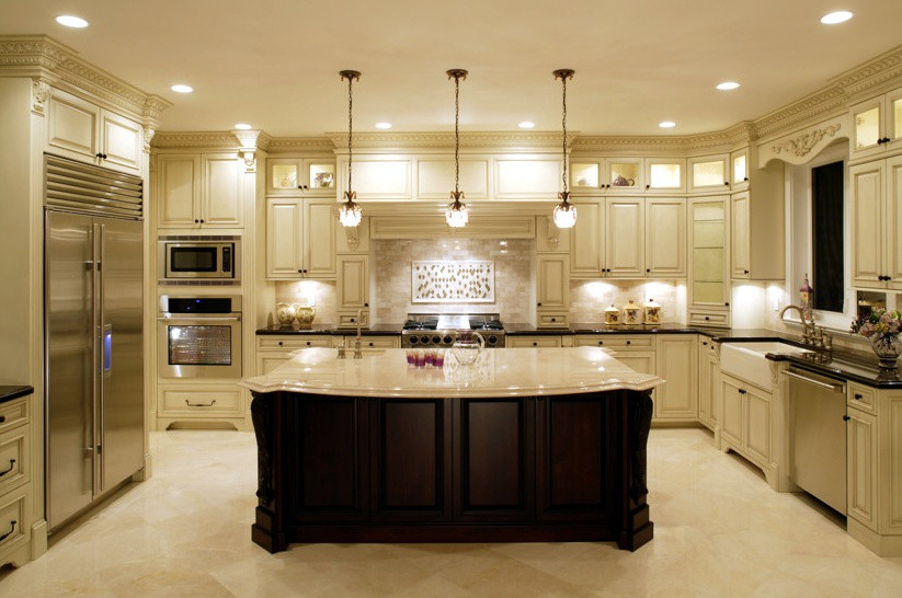 Large traditional l-shaped separate kitchen in New York with a farmhouse sink, raised-panel cabinets, beige cabinets, quartzite benchtops, beige splashback, stainless steel appliances, travertine floors, with island, beige floor, mosaic tile splashback and beige benchtop.