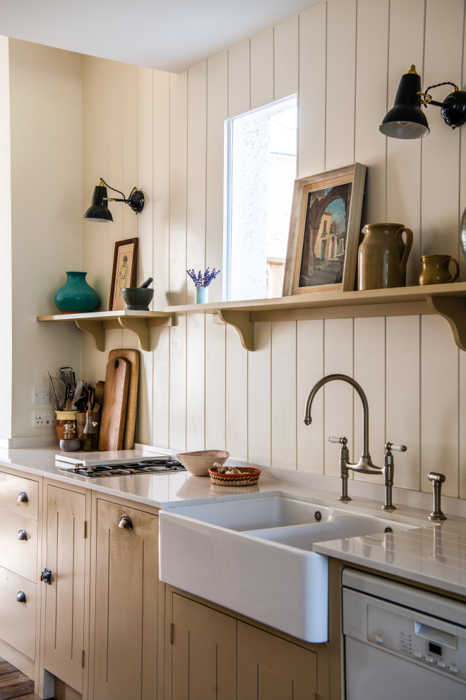 Inspiration for a mid-sized country single-wall open plan kitchen in London with a farmhouse sink, beaded inset cabinets, beige cabinets, marble benchtops, no island, brown floor and white benchtop.