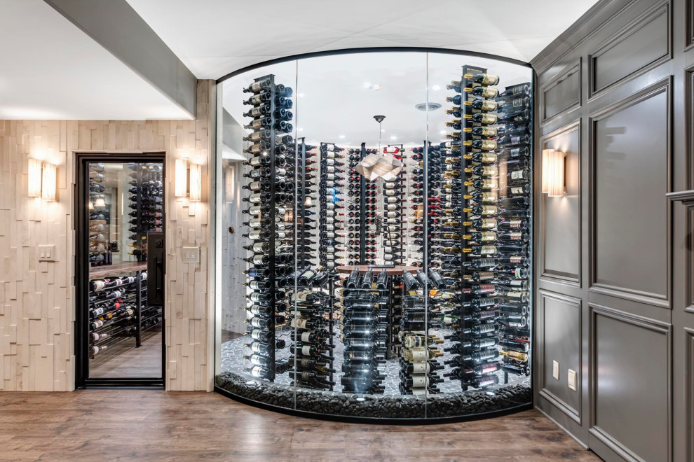 This is an example of a medium sized rustic wine cellar in Columbus with concrete flooring, storage racks, grey floors and feature lighting.