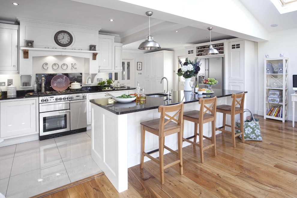 Photo of a contemporary kitchen in Dublin with stainless steel appliances and white floor.