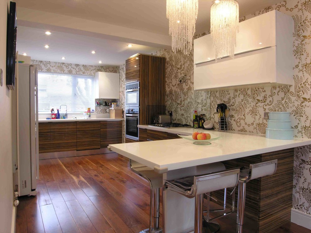 Design ideas for a contemporary u-shaped separate kitchen in London with flat-panel cabinets.