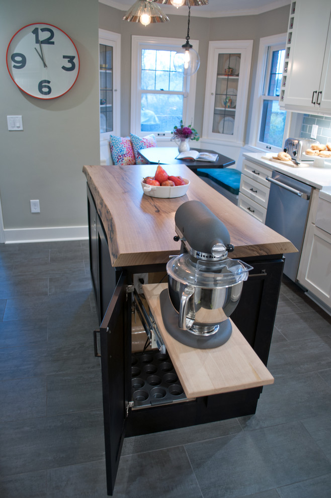 Photo of a small transitional u-shaped separate kitchen in Seattle with a farmhouse sink, shaker cabinets, white cabinets, quartzite benchtops, blue splashback, glass tile splashback, stainless steel appliances, porcelain floors, with island and grey floor.