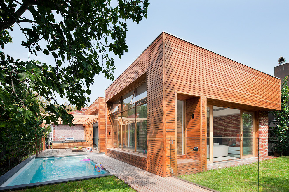 This is an example of a mid-sized contemporary one-storey exterior in Melbourne with wood siding and a flat roof.