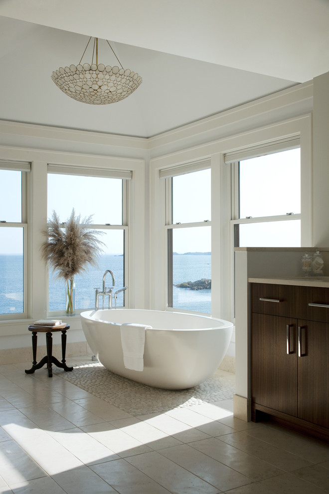 Design ideas for a transitional bathroom in Boston with a freestanding tub and pebble tile floors.