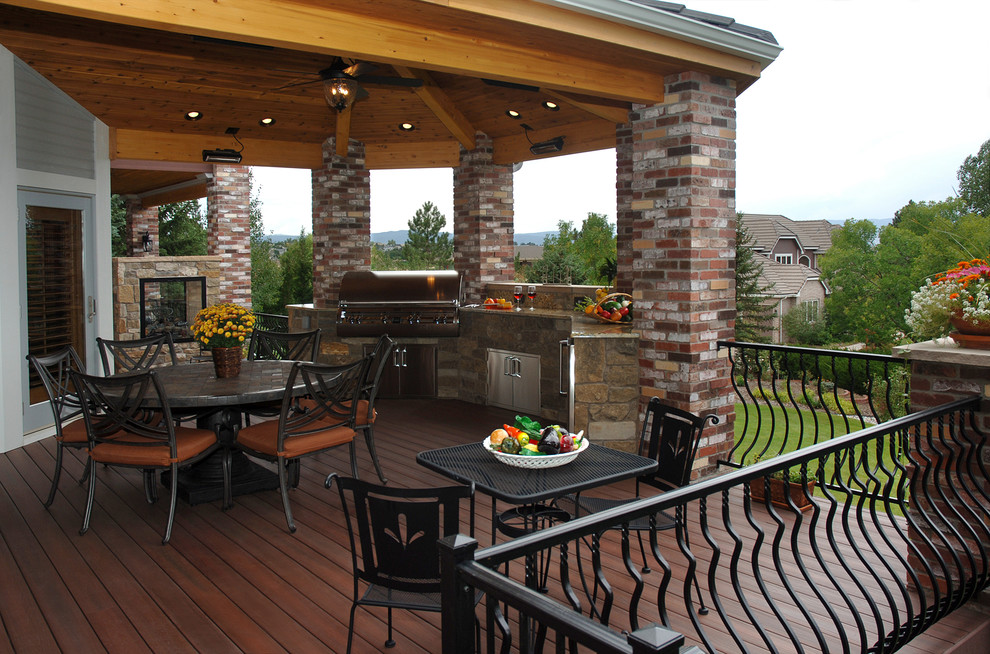 Photo of a transitional deck in Charlotte with an outdoor kitchen and a roof extension.