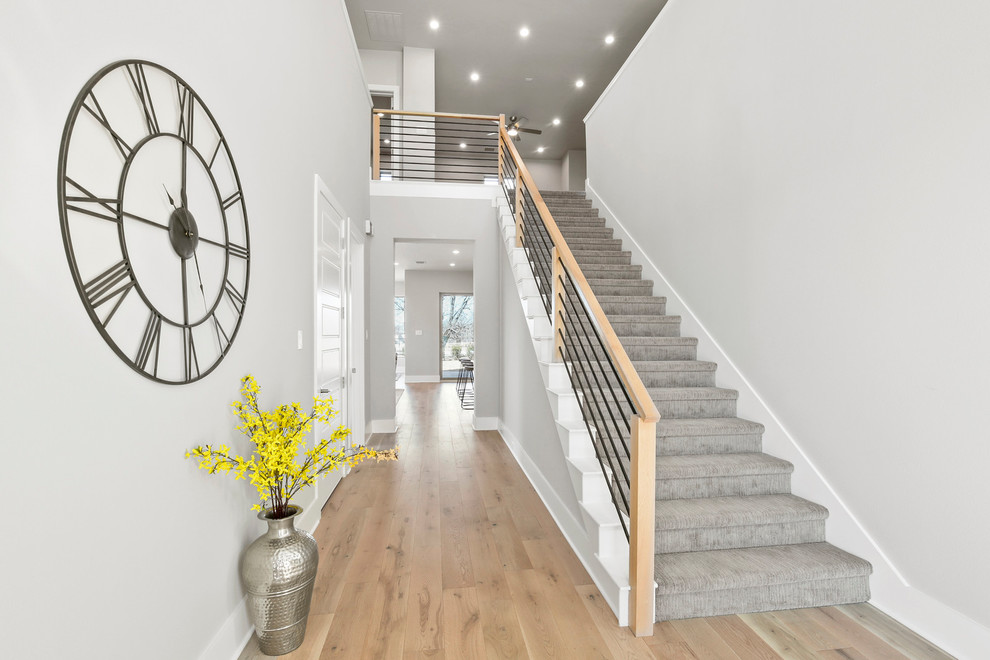 Design ideas for a large modern carpeted straight staircase in Dallas with carpet risers and mixed railing.