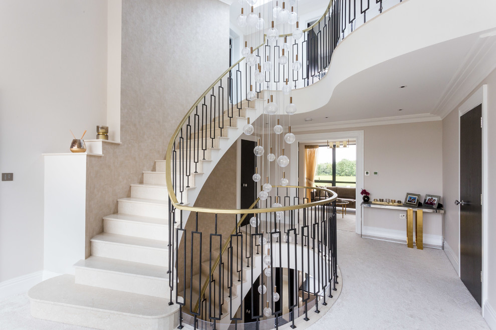 Inspiration for a mid-sized transitional curved staircase in Hertfordshire with metal railing.