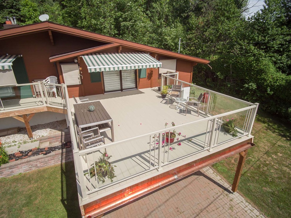 Large transitional rooftop deck photo in Ottawa with no cover
