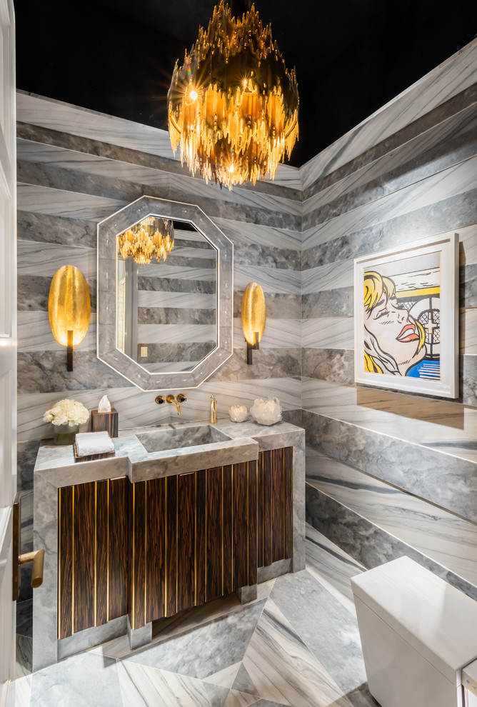Inspiration for a mediterranean powder room in Miami with dark wood cabinets, marble, marble floors, an integrated sink, marble benchtops, furniture-like cabinets, gray tile, grey walls, grey floor and grey benchtops.