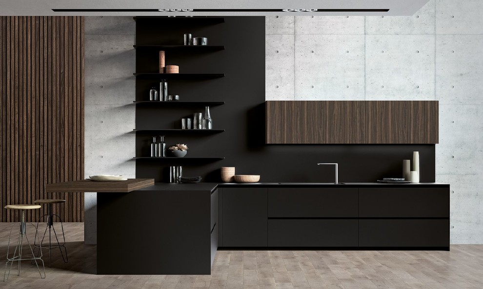 This is an example of an expansive contemporary l-shaped open plan kitchen in San Francisco with a drop-in sink, flat-panel cabinets, black cabinets, solid surface benchtops, black splashback, stone slab splashback, panelled appliances, light hardwood floors, no island, beige floor and black benchtop.