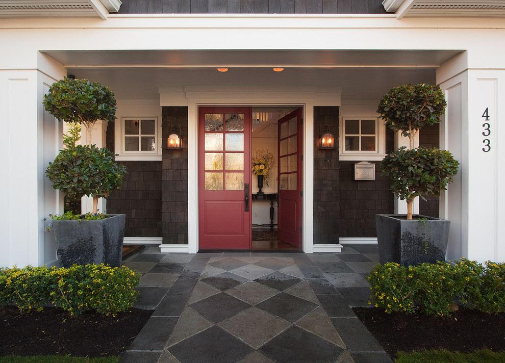 Traditional entryway in Seattle with a double front door and a red front door.