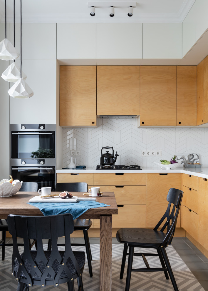 This is an example of a mid-sized scandinavian l-shaped eat-in kitchen in Saint Petersburg with flat-panel cabinets, yellow cabinets, solid surface benchtops, white splashback, ceramic splashback, ceramic floors, no island, grey floor and white benchtop.