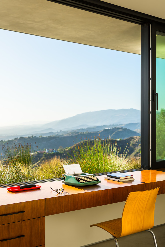 This is an example of a contemporary study room in Santa Barbara with a built-in desk.