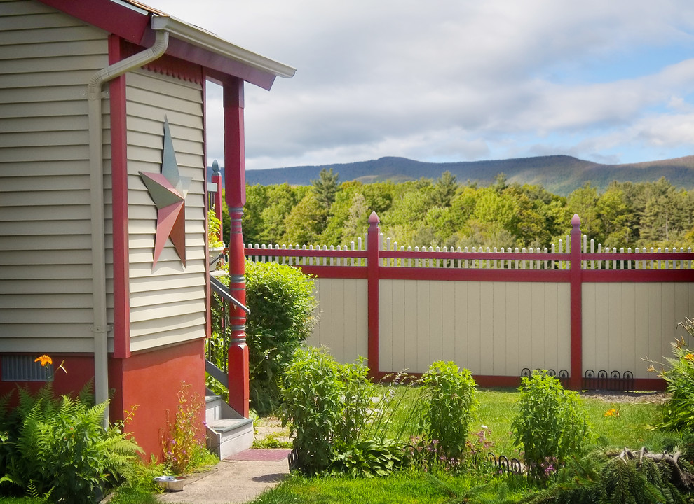 This is an example of a traditional garden in New York with a vinyl fence.