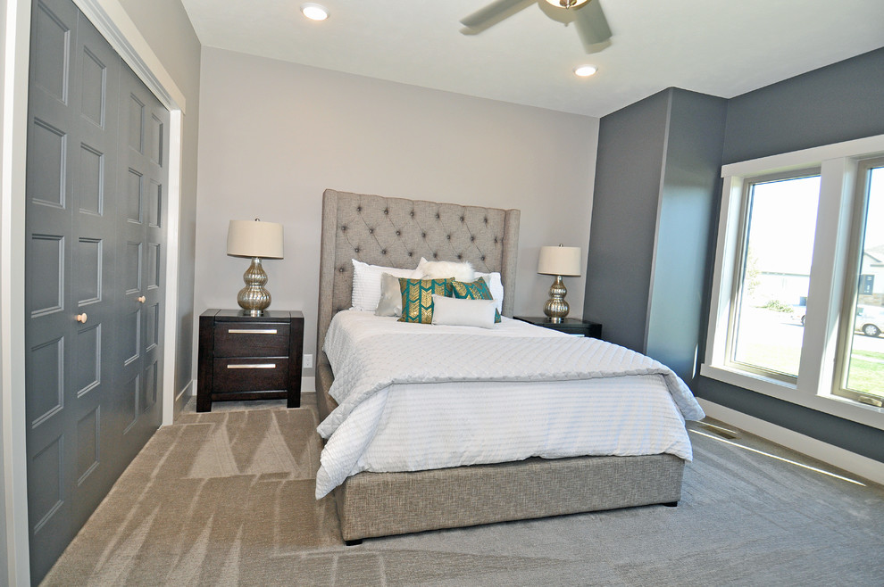 This is an example of a mid-sized transitional guest bedroom in Other with grey walls, carpet and no fireplace.