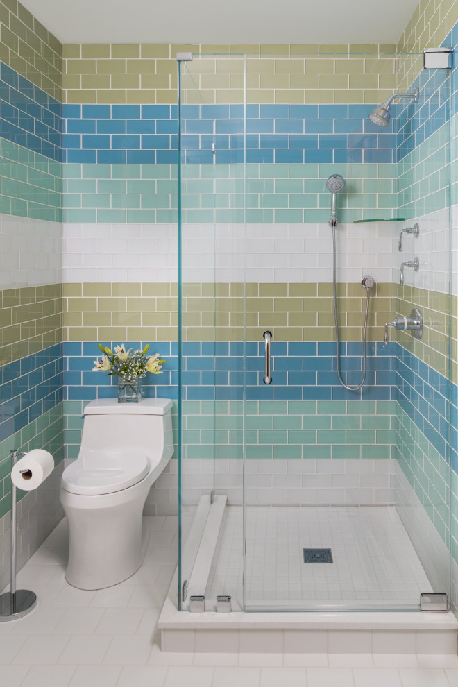 Small beach style kids bathroom in Boston with furniture-like cabinets, blue cabinets, a corner shower, a one-piece toilet, green tile, glass tile, green walls, porcelain floors, an undermount sink, engineered quartz benchtops, white floor, a hinged shower door and white benchtops.