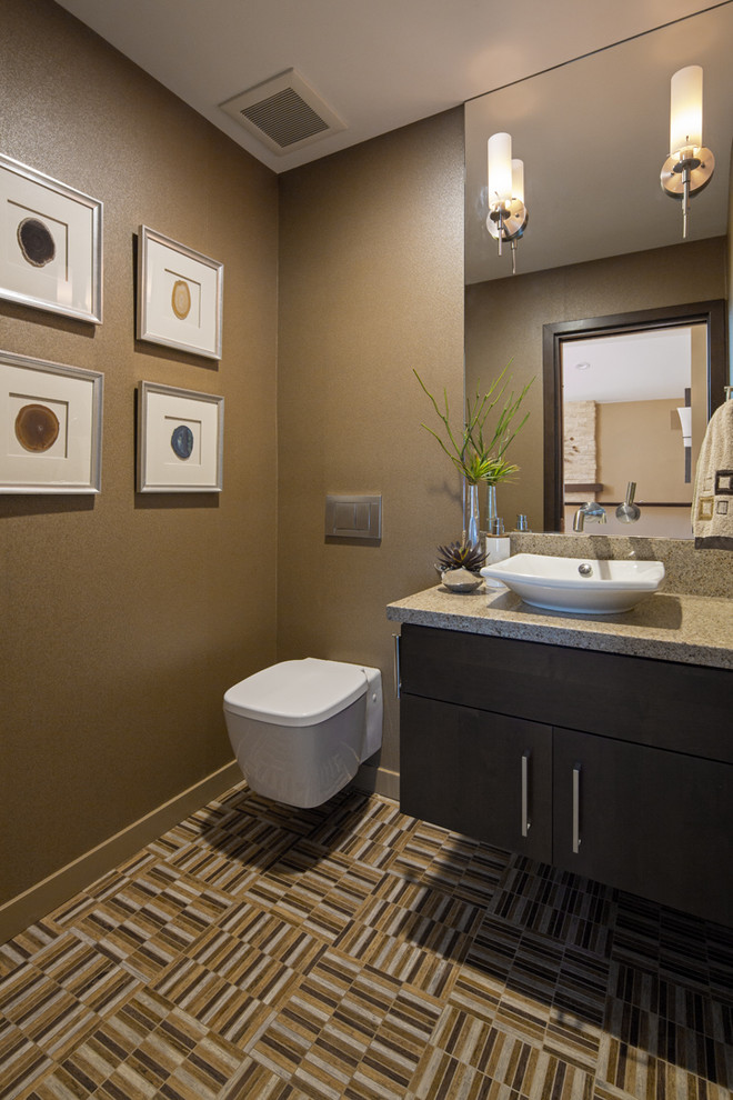 Contemporary powder room in Orange County with a vessel sink, flat-panel cabinets, dark wood cabinets, engineered quartz benchtops, a wall-mount toilet, brown walls and porcelain floors.