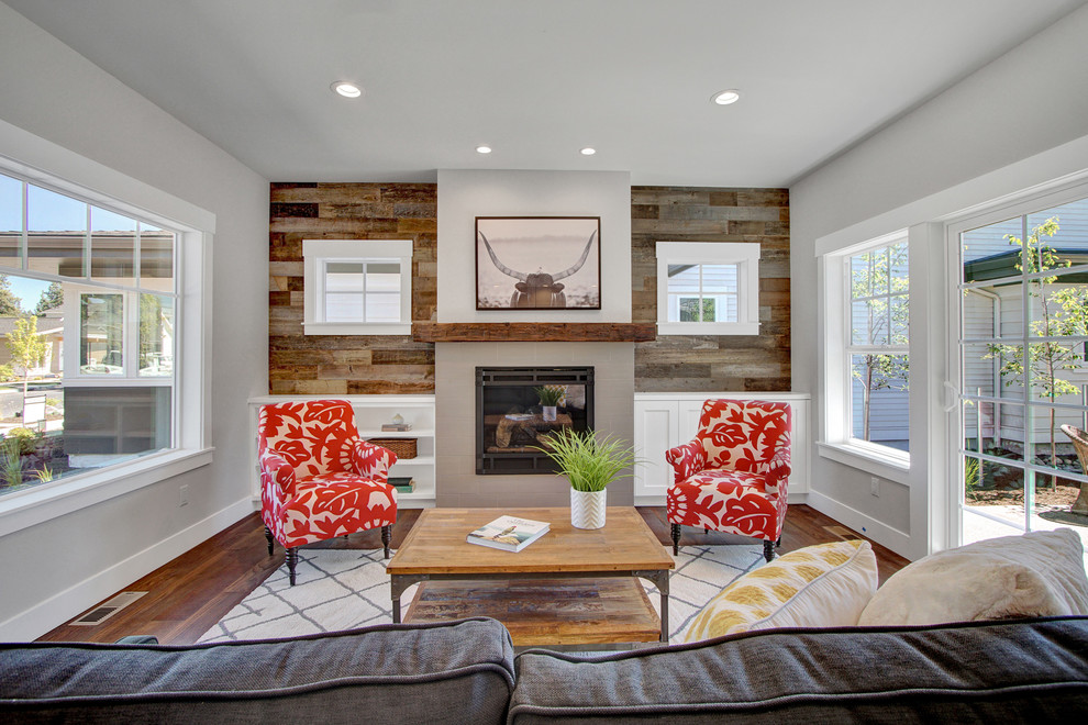 This is an example of a mid-sized arts and crafts open concept living room in Other with grey walls, medium hardwood floors, a standard fireplace, a tile fireplace surround, no tv and brown floor.