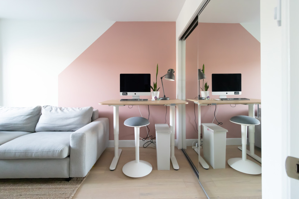 Diseño de despacho contemporáneo pequeño con suelo de madera clara, escritorio independiente, paredes rosas y suelo beige
