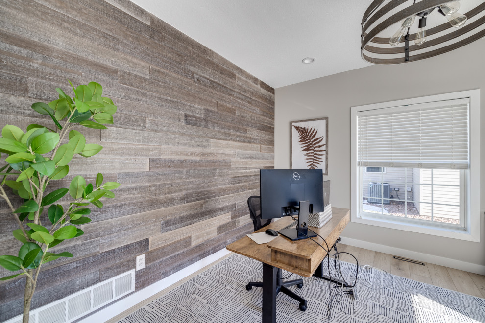 This is an example of a mid-sized transitional home office in Other with beige walls, vinyl floors, a freestanding desk, beige floor and planked wall panelling.