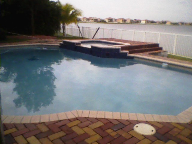 Mid-sized mountain style pool photo in Miami