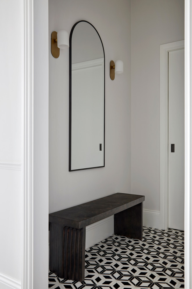 Expansive contemporary hallway in London with white walls, ceramic flooring, a single front door, a black front door, black floors and a dado rail.