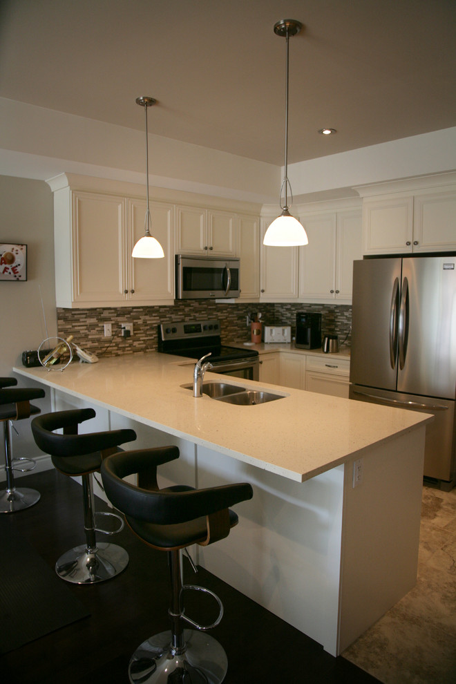 Eat-in kitchen - small transitional u-shaped porcelain tile eat-in kitchen idea in Toronto with an undermount sink, flat-panel cabinets, white cabinets, solid surface countertops, beige backsplash, glass tile backsplash, stainless steel appliances and an island